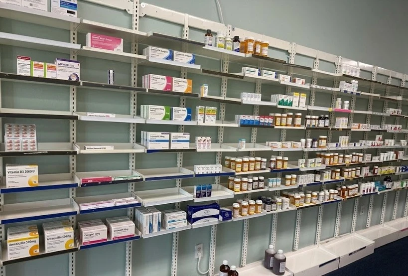 Organized pharmacy shelves with prescription products